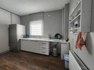 a kitchen with a white refrigerator and a sink at Kabaklı Konaklama Turizm Amaçlı Kiralık Konut in Kabaklı