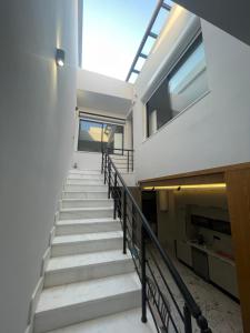 a staircase in a building with a skylight at Charmante maison de ville in Bin Rhilouf