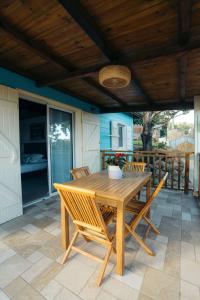 a wooden table and chairs on a patio at Les Ti Kaz d'Auguste in Les Avirons +53 photos