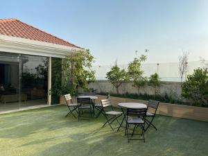 a group of chairs and tables on a patio at كورت للشقق المخدومة in Al Khobar