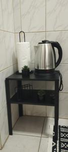 a tea kettle sitting on a black stand in a kitchen at Centar Novi Sad in Novi Sad +11 photos