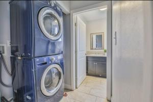 a blue washer and dryer in a bathroom at Lovely Private Bedroom Near SoFi/USC in Los Angeles