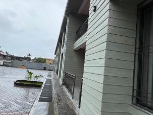 a side of a building with a fence next to it at Aberdeen Richview Luxury Apartments- Entire One Bedroom Apartment D201 in Freetown