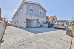 a car parked in front of a house with a garage at Lovely Private Bedroom Near SoFi/USC in Los Angeles