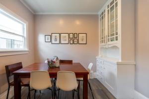 a dining room with a wooden table and chairs at Oak Manor - Chic & Stylish 2BR Apartment Retreat in Oakland