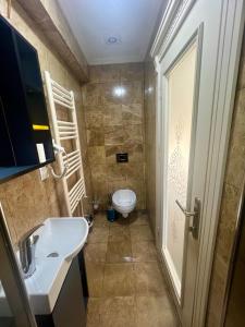 a bathroom with a toilet and a sink at LA MAİSON FAMILY Hotel in Istanbul +3 photos