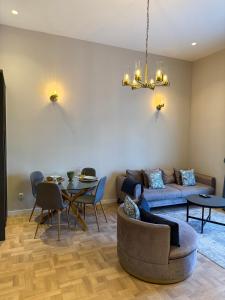 a living room with a couch and a table at Cozy Urban Apartment in Pristina