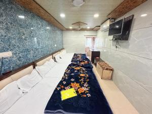 a conference room with a long table with flowers on it at Hotel Shree dhan Laxmi palace in Jāmb
