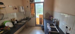 a kitchen with a sink and a counter top at 2BHK kitchen wi-fi Vatika in Gurgaon
