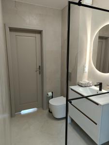 a bathroom with a toilet and a sink and a mirror at Willa Róż in Rusinowo +20 photos