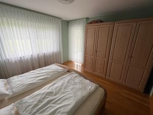 a bedroom with a bed and a large window at Naturblick am Dorfausgang in Rheinau