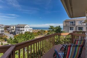 a balcony with two chairs and a view of the ocean at Dunes reach 2 in Dewey Beach