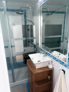 a bathroom with a sink and a glass shower at VISTAS ROCA MAR in La Línea de la Concepción +19 photos