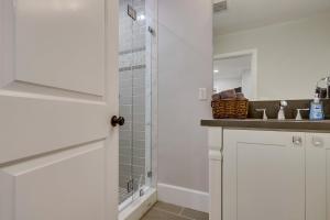a white bathroom with a shower and a sink at 5 Bedroom plus loft room, 3 Bath home in Fullerton