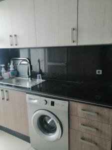 a kitchen with a washing machine and a sink at Les terrasses 2 in Mansouria