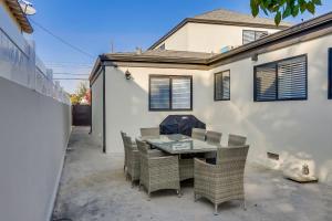 a patio with a table and chairs in front of a house at 5 Bedroom plus loft room, 3 Bath home in Fullerton +21 photos