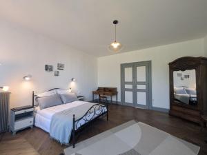 a bedroom with a bed and a large mirror at Maison de caractère au calme - FR-1-611-118 