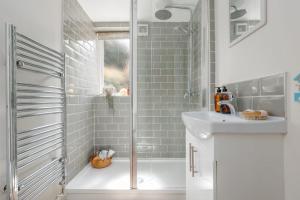 a bathroom with a shower and a sink at Angel Cottage in Swanage +19 photos