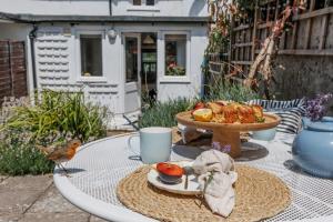 a table with a bird sitting on top of it at Angel Cottage in Swanage