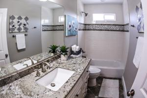 a bathroom with a sink and a toilet and a tub at Adorable 3 Bedroom 2 Bath Home in Fullerton