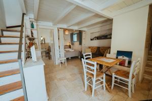 a kitchen and dining room with a table and chairs at i Trulli di Figazzano in Locorotondo