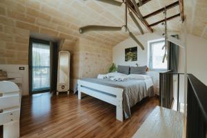 a bedroom with a large bed in a brick wall at i Trulli di Figazzano in Locorotondo +83 photos