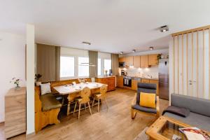 a kitchen and dining room with a table and chairs at s`Hauserl 311 - Your Austrian Home in Altaussee
