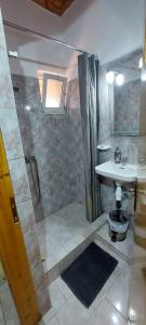 a bathroom with a shower and a sink at Villa Nefeli in Loutsa +54 photos