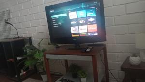 a television sitting on top of a wooden table at APARTAMENTO In HOUSE ALAMEDA in Santiago