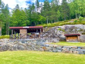 a building on top of a rocky hill with a bridge at Raundalen in Løyte