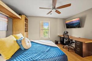 a bedroom with a blue bed and a desk at Smoky View Haven- Indoor Pool, Playground, Walking Trail, Hot Tub in Pigeon Forge +41 photos