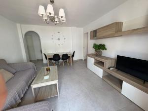 A television and/or entertainment centre at Apto. Escolano, Playa de la Cachucha. WiFi, A/C