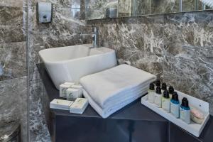 a bathroom with a sink and a counter with bottles of wine at Gen Suites in Istanbul