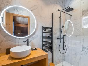 a bathroom with a white sink and a mirror at Chalet neuf 10 pers, charme et confort à Serre Chevalier - FR-1-808-20 in Le Monêtier-les-Bains +7 photos