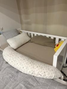 a bed with a white frame and pillows on the floor at Wunderschöne Wohnung in Erftstadt-Liblar 15 Minuten bis zum Phantasialand! in Erftstadt