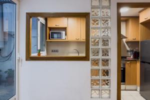 a kitchen with a glass block wall with a microwave at Casa en Barcelona in Barcelona +27 photos