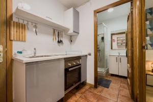 a kitchen with a sink and a stove at Casa en Barcelona in Barcelona +27 photos