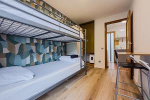 a bedroom with two bunk beds and a hallway at Casa en Barcelona in Barcelona