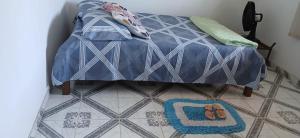 a bedroom with a bed with a pair of shoes on the floor at Aguiar beach house in Salinópolis