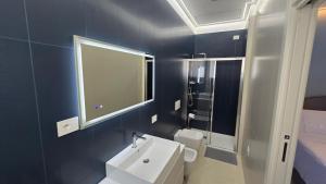 a bathroom with a white sink and a mirror at RESIDENZA GIULIA e LIDIA - PERLA DELL'ADRIATICO in Grottammare +65 photos