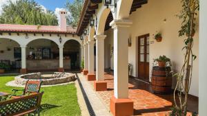 a courtyard of a house with a fountain at Iraola Hotel Boutique in Cafayate