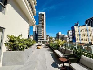 a balcony with couches and plants on a building at Apto completo em Pinheiros. Estilo e Conforto! in Sao Paulo