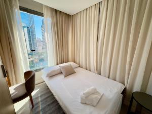 a hotel room with a bed and a window at Apto completo em Pinheiros. Estilo e Conforto! in Sao Paulo +58 photos