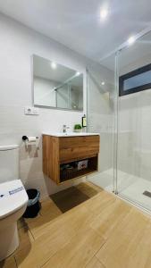 a bathroom with a shower and a sink and a toilet at Apartamentos Ladera del Castillo in Cazorla +43 photos