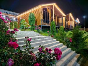a group of stairs with flowers in front of a building at Royal Ak-Terek Issyk-kul in Ak-Terek