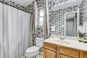 a bathroom with a toilet and a sink and a mirror at 15 Mins to Hospital&Downtown! Brandlewood Bungalow in Savannah