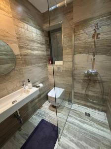 a bathroom with a shower and a toilet and a sink at Simons Apartments minutes away from Balluta Bay and St Julians in Sliema +179 photos