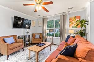 a living room with a couch and a ceiling fan at 20 Mins from the Airport- Sunny Soling Hideaway in Savannah