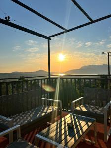 a balcony with a view of the ocean and the sunset at A&A apartments in Kotor