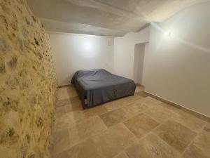 a bedroom with a bed in the corner of a room at Atypical house with terrace in Salles-sous-Bois